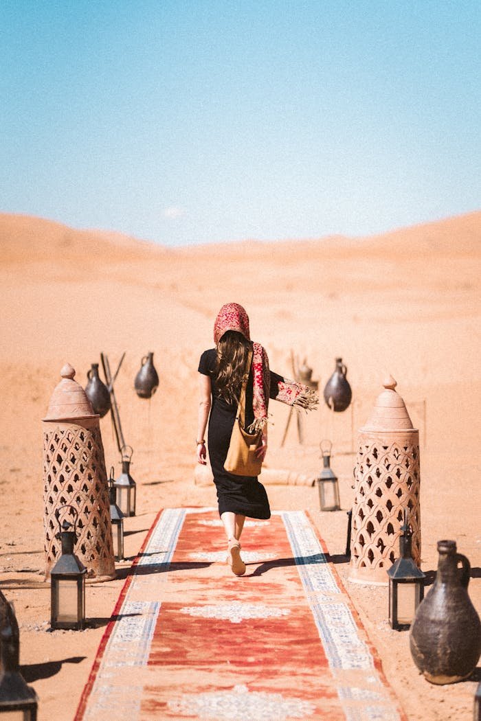 Back View of a Woman Walking on Carpet on Desert